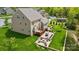 Aerial view of a backyard with a pool, outdoor kitchen, deck and a brick patio with fire pit at 5140 Oak Grove Pl, Waxhaw, NC 28173