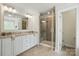 Bright bathroom featuring a double vanity with granite countertop and a glass shower at 5140 Oak Grove Pl, Waxhaw, NC 28173