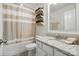 Clean bathroom featuring a granite vanity and shower/tub with towel storage at 5140 Oak Grove Pl, Waxhaw, NC 28173