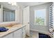 Bright bathroom featuring a granite vanity, tiled floor, and tub with a striped shower curtain at 5140 Oak Grove Pl, Waxhaw, NC 28173