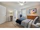 Bright bedroom with a world map art piece, wood dresser and ceiling fan at 5140 Oak Grove Pl, Waxhaw, NC 28173
