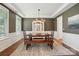 Formal dining room with wainscoting trim, a buffet cabinet, and a decorative light fixture at 5140 Oak Grove Pl, Waxhaw, NC 28173