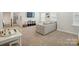 Cozy living room featuring neutral carpet, a sectional sofa, and a play area at 5140 Oak Grove Pl, Waxhaw, NC 28173