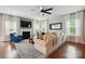 Cozy living room featuring a fireplace, hardwood floors, and comfortable seating at 5140 Oak Grove Pl, Waxhaw, NC 28173