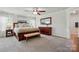 Elegant main bedroom suite featuring a large bed, side tables and natural light at 5140 Oak Grove Pl, Waxhaw, NC 28173