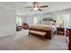 Spacious main bedroom suite featuring a large bed, sitting area, and natural light at 5140 Oak Grove Pl, Waxhaw, NC 28173