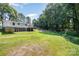 Expansive lawn surrounding the house with mature trees and a back deck, offering a serene outdoor retreat at 5275 Long Ferry Rd, Salisbury, NC 28146