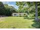 Charming single-story home featuring a welcoming front yard, complemented by mature trees and simple landscaping at 5275 Long Ferry Rd, Salisbury, NC 28146