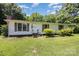 Close up of a cozy one story home with shuttered windows and simple landscaping on a verdant lawn at 5275 Long Ferry Rd, Salisbury, NC 28146