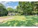 A quaint single-story home sits on a lush, tree-filled lot, offering a peaceful and private setting at 5275 Long Ferry Rd, Salisbury, NC 28146