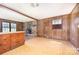 Rustic living room with wood paneling, a stone fireplace, and a unique built-in cabinet at 5275 Long Ferry Rd, Salisbury, NC 28146
