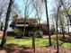 Brick home featuring multiple decks overlooking a private, wooded backyard, perfect for entertaining at 5309 Silchester Ln, Charlotte, NC 28215