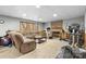 Basement with fireplace, cozy couch, and exercise equipment for activities and relaxation at 5309 Silchester Ln, Charlotte, NC 28215