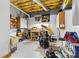 Basement workshop with a drum kit, storage cabinets, and work table at 5309 Silchester Ln, Charlotte, NC 28215