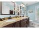 Bright bathroom featuring dual sinks, granite countertops, and elegant decorative touches at 5309 Silchester Ln, Charlotte, NC 28215
