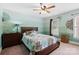 Cozy bedroom with a floral accent wall, ceiling fan, and natural light at 5309 Silchester Ln, Charlotte, NC 28215