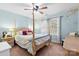 Serene bedroom with four poster bed, bedside tables and chandelier at 5309 Silchester Ln, Charlotte, NC 28215