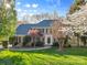 Charming two-story brick home with a lush green lawn and mature trees in a desirable neighborhood at 5309 Silchester Ln, Charlotte, NC 28215