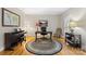 Dedicated home office featuring hardwood floors, a large desk, and ample natural light, perfect for remote work at 5309 Silchester Ln, Charlotte, NC 28215