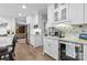 Bright kitchen featuring white cabinets, granite countertops, stainless steel appliances, and hardwood floors at 5309 Silchester Ln, Charlotte, NC 28215
