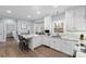 Bright and airy kitchen with white cabinets, granite countertops, and a kitchen island with seating at 5309 Silchester Ln, Charlotte, NC 28215