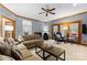 Spacious living room with cozy seating, a ceiling fan, and access to the outdoors at 5309 Silchester Ln, Charlotte, NC 28215