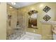 Elegant tiled shower features glass surround, stone floor, and convenient built-in shelving at 5309 Silchester Ln, Charlotte, NC 28215
