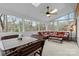Bright sunroom with comfortable seating, ceiling fan, and views of the outdoors at 5309 Silchester Ln, Charlotte, NC 28215
