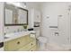 This updated bathroom boasts modern fixtures, a framed mirror, and convenient storage at 5909 Quail Hollow Rd # B, Charlotte, NC 28210