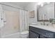 A bathroom with a shower, vanity, updated fixtures, and an overhead mirror at 5909 Quail Hollow Rd # B, Charlotte, NC 28210