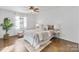 Bright bedroom with a ceiling fan, neutral decor, and hardwood floors for a clean and inviting space at 5909 Quail Hollow Rd # B, Charlotte, NC 28210