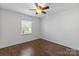 This cozy bedroom offers wood-look flooring and a ceiling fan, perfect for relaxation at 5909 Quail Hollow Rd # B, Charlotte, NC 28210