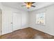 This bright bedroom features hardwood floors, white walls and a convenient closet at 5909 Quail Hollow Rd # B, Charlotte, NC 28210