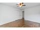 This bedroom has hardwood floors, a closet, and a ceiling fan for added comfort at 5909 Quail Hollow Rd # B, Charlotte, NC 28210