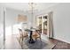 Bright dining room features modern chandelier, dine-in table, hardwood floors, and backyard access at 5909 Quail Hollow Rd # B, Charlotte, NC 28210
