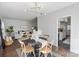 Bright dining room features modern chandelier, hardwood floors, and seamless access to living room at 5909 Quail Hollow Rd # B, Charlotte, NC 28210