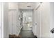 Welcoming entryway with slate floors leading to bright living area, adjacent to a double-door closet at 5909 Quail Hollow Rd # B, Charlotte, NC 28210