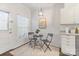 Bright kitchen features a dine-in table, access to backyard, and white cabinetry at 5909 Quail Hollow Rd # B, Charlotte, NC 28210