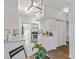 Bright kitchen with stainless steel appliances, stone countertops, white cabinetry, and dine-in table at 5909 Quail Hollow Rd # B, Charlotte, NC 28210