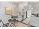 Bright kitchen features stainless steel appliances, white cabinetry, dine-in table, and access to backyard at 5909 Quail Hollow Rd # B, Charlotte, NC 28210