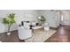 This living room features a neutral palette, modern furniture and fixtures, and beautiful hardwood floors at 5909 Quail Hollow Rd # B, Charlotte, NC 28210