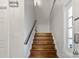 Staircase with wooden stairs, a black handrail, and a window providing natural light at 5909 Quail Hollow Rd # B, Charlotte, NC 28210