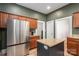 This kitchen features a large stainless steel refrigerator, a kitchen island, and dark green walls at 615 E Sycamore St, Lincolnton, NC 28092