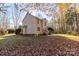 View of the rear exterior showing the lush landscaping with mature trees and a concrete patio at 617 Edinburgh Ct, Rock Hill, SC 29730