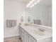 Bathroom featuring a large mirror, dual sinks, modern lighting, and neutral paint at 617 Edinburgh Ct, Rock Hill, SC 29730