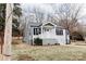 A single-story home with gray vinyl siding, a chimney and a welcoming front porch at 634 Mckee St, Albemarle, NC 28001