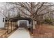 Detached garage with carport offering additional parking and storage solutions at 634 Mckee St, Albemarle, NC 28001