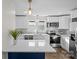 Open concept kitchen with an island, stainless steel appliances and modern light fixtures at 691 Gibson Nw Dr, Concord, NC 28025