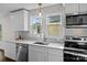 Bright kitchen with stainless appliances, quartz countertops, stylish backsplash and large windows at 691 Gibson Nw Dr, Concord, NC 28025