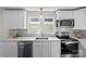 Updated kitchen with stainless steel appliances, quartz countertops, and modern fixtures at 691 Gibson Nw Dr, Concord, NC 28025
